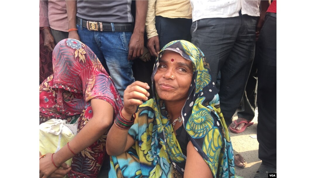 Women are among those looking for work as labor on building projects to supplement family incomes. (A. Pasricha/VOA)