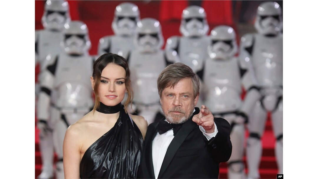 FILE - Actors Daisy Ridley and Mark Hamill pose for photographers upon arrival at the premiere of "Star Wars: The Last Jedi" in London, Dec. 12, 2017.
