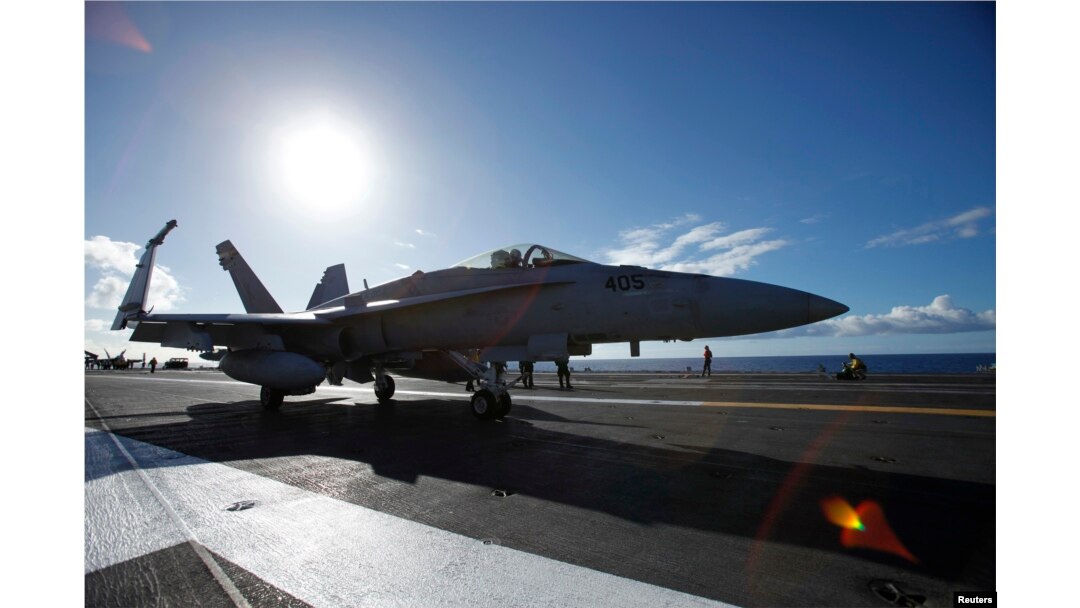 FILE - A F/A 18E Super Hornet on the USS Ronald Reagan taxis on deck before take off.