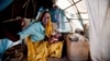 Ashia Saleh, from Barkatil village, holds her baby inside a make shift tent at the Kalma refugee camp for internally displaced people, south of the Darfur town of Nyala, Sudan, Mar. 9, 2014. (Credit: UNAMID)