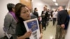 Teamster member Rocio Mejia, a supporter of a proposal to raise the state's minimum wage, joins others outside the Assembly Chambers calling for Assembly members to approve the measure, March 31, 2016, in Sacramento, California.
