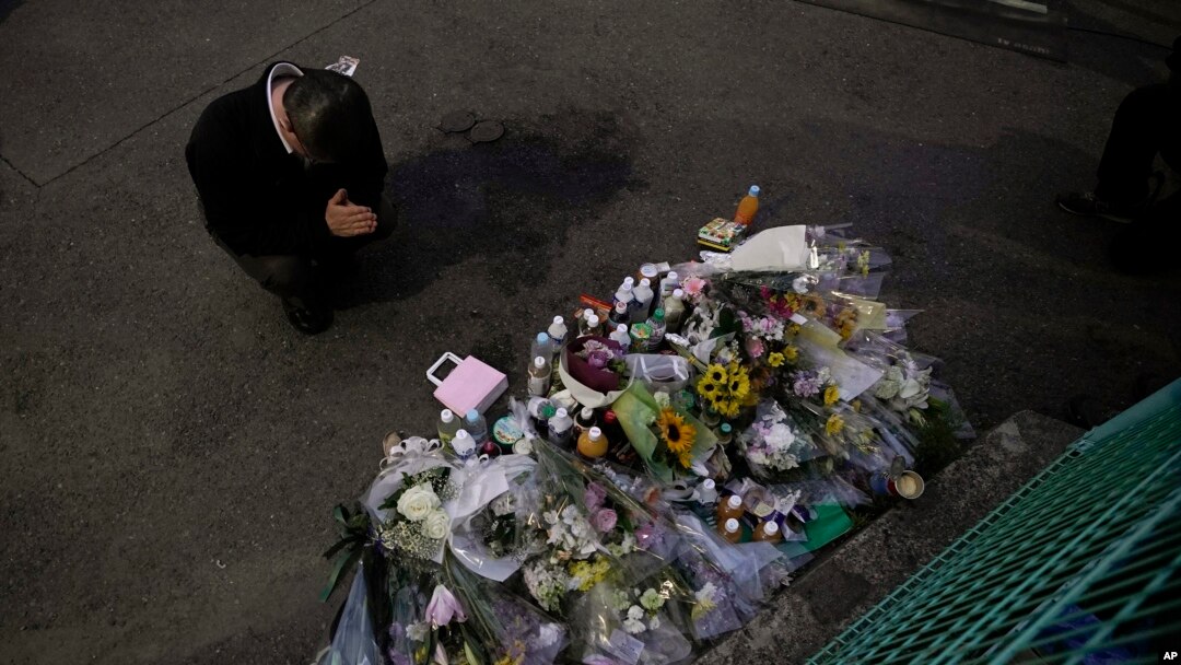 A man pays respects at a makeshift memorial for the victims of a knife attack, May 28, 2019, in Kawasaki, just outside Tokyo.