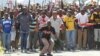 Miners sing and dance as they march to Lonmin Platinum Mine near Rustenburg, South Africa, Monday, Sept. 10, 2012, in an attempt to stop operations. 