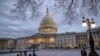 People walk by the U.S. Capitol in Washington, Jan. 21, 2018.