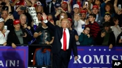 U.S. President Donald Trump waves after a campaign rally in Washington Township, Michigan, April 28, 2018.