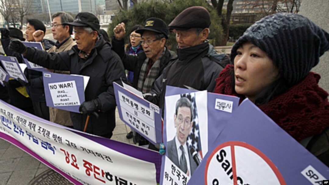 Activists chant slogans during a news conference denouncing U.S. sanctions on Iran in front of the foreign ministry, where the U.S. State Department's special adviser for nonproliferation and arms control, Robert Einhorn is to meet South Korean Deputy For