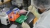 FILE - A research scientist works inside a laboratory of India's Serum Institute, the world's largest maker of vaccines, which is working on vaccines against COVID-19 in Pune, India, May 18, 2020. 