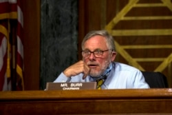 FILE - Senator Richard Burr listens as Rep. John Ratcliffe testifies before the Senate Select Committee on Intelligence during his nomination hearing to become director of national intelligence on Capitol Hill in Washington, May 5, 2020.