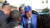 Uhuru Kenyatta (C) arrives at the Jomo Kenyatta International Airport as he departs to attend a hearing at the International Criminal Court at The Hague, in Nairobi, October 7, 2014.