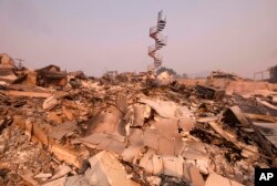 The charred remains of the burned out home are seen in Malibu, Calif., Nov. 10, 2018.