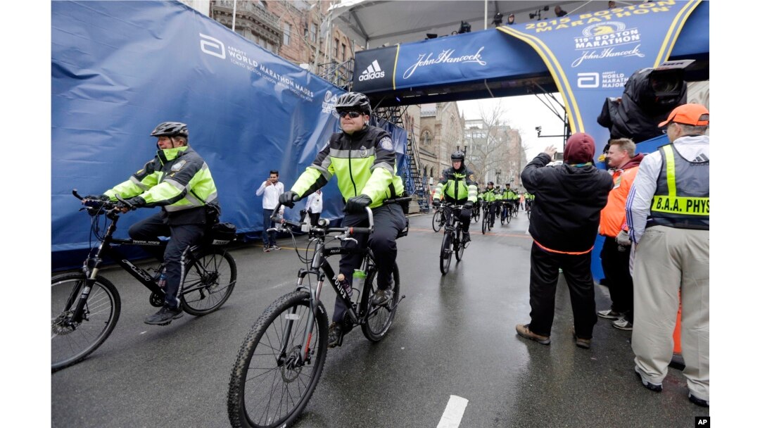 FILE - Police officers patrol near the finish line of the Boston Marathon in Boston, April 20, 2015.