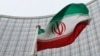 FILE - An Iranian flag flutters in front of the International Atomic Energy Agency (IAEA) headquarters in Vienna, Austria, Jan. 15, 2016. 