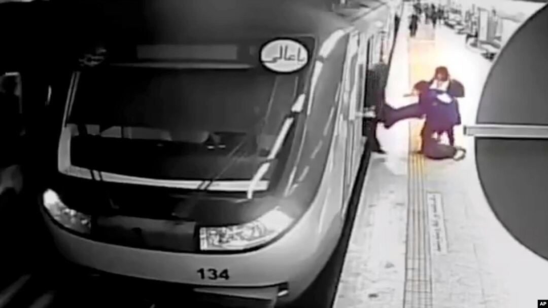 FILE - In this image from surveillance video aired by Iranian state television, women pull 16-year-old Armita Geravand from a train car on the Tehran Metro in Tehran, Iran, on Oct. 1, 2023.
