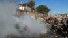 Iraqi firefighters distinguish a fire at the scene of a bomb attack in Kirkuk, 180 miles (290 kilometers) north of Baghdad, Iraq, February 3, 2013.