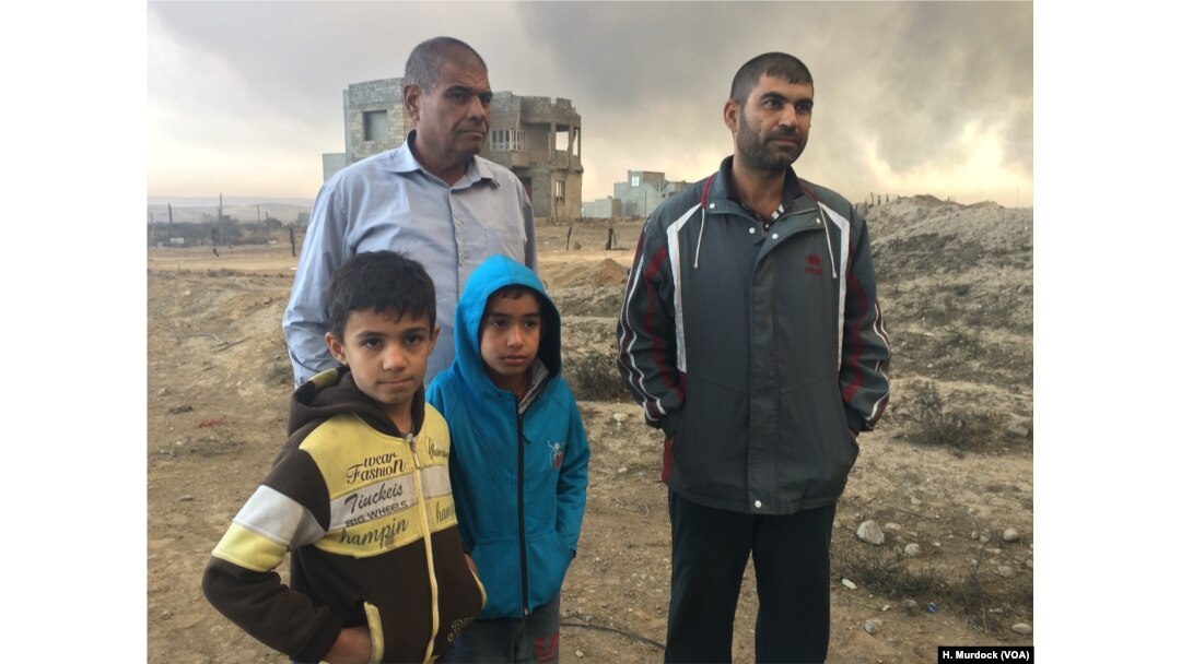 "Even our spit is dry and black," says one father who's family did not leave the area for Islamic State or the fires. "Life here is finished," he added, in Qayyarah, Iraq, Nov. 5, 2016.