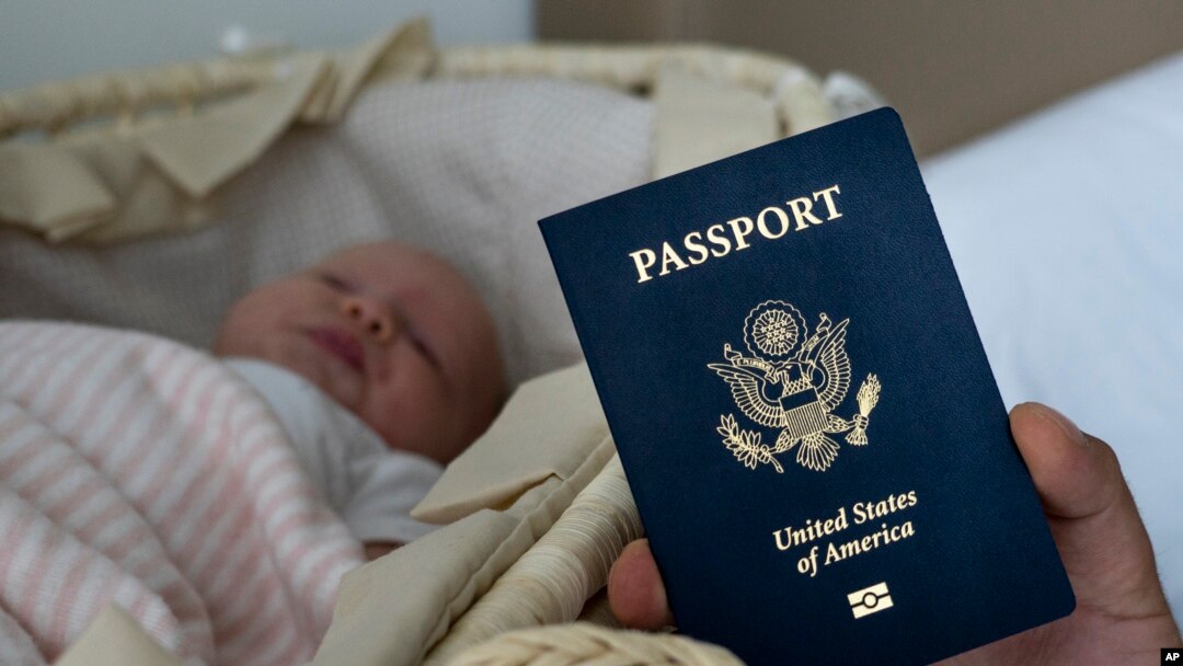 In this photo taken on Jan. 24, 2019, Denis Wolok, the father of 1-month-old Eva, shows the child's U.S. passport during an interview with The Associated Press in Hollywood, Fla. 