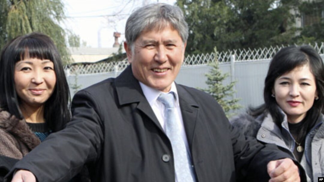 Former PM and Russia's favored candidate, Almazbek Atambayev (C), who was declared winner of Kyrgyzstan's presidential elections, talks to journalists in the capital Bishkek, October 31, 2011.