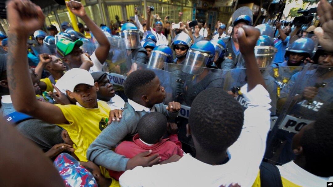 Protesters clash with police near parliament in Cape Town, South Africa, Feb. 9, 2017 prior to it's opening and a national address by President Jacob Zuma. Hundreds of armed forces have been deployed to increase security as opposition groups denounce Zuma, saying he should resign.