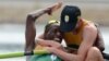 South Africa rowers Sizwe Ndlovu, left, and John Smith embrace after winning the gold medal in the men's lightweight four rowing final at the London 2012 Summer Olympics in Eton Dorney, near Windsor, England, August 2, 2012.