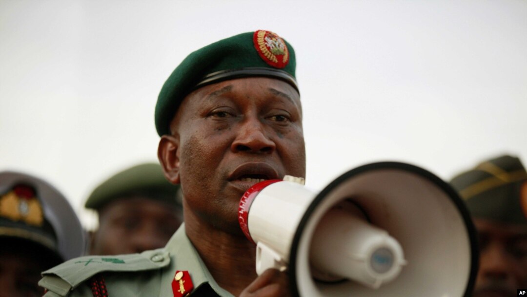 Brig. Gen. Chris Olukolade speaks to people at a demonstration calling on the government to rescue the kidnapped school girls from the Chibok government secondary school, outside the defense headquarters, in Abuja, May 6, 2014.