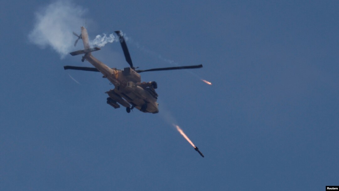 An Israeli military Apache helicopter fires missiles towards Gaza, amid the ongoing conflict between Israel and the Palestinian Islamist group Hamas, as seen from southern Israel, May 14, 2024.