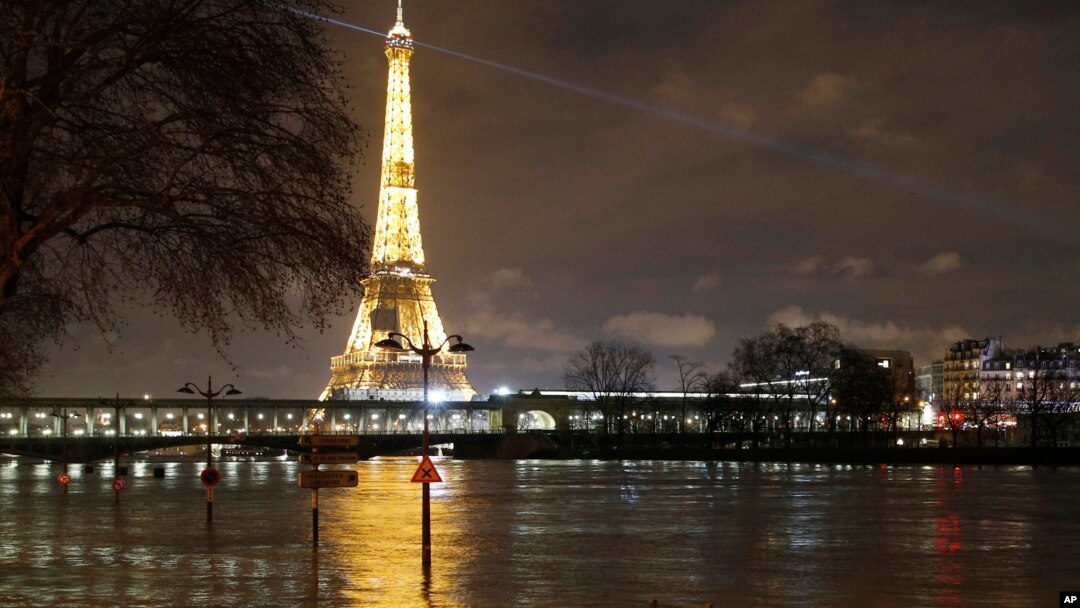 A flooded street lamp and signboards are pictured next to the river Seine in Parison the river Seine in Paris, Jan. 27, 2018. 