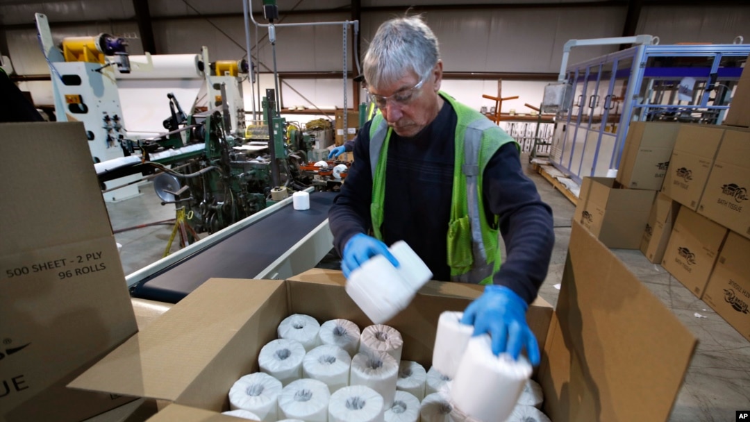 Scott Mitchell fills a box with toilet paper at the Tissue Plus factory, Wednesday, March 18, 2020, in Bangor, Maine. The new company has been unexpectedly busy because of the shortage of toilet paper brought on by hoarders concerned about the coronavirus