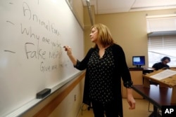 FILE - Pat Winters Lauro, a journalism professor at Kean University in Union, N.J., leads a class discussion about fake news, Jan. 20, 2017.