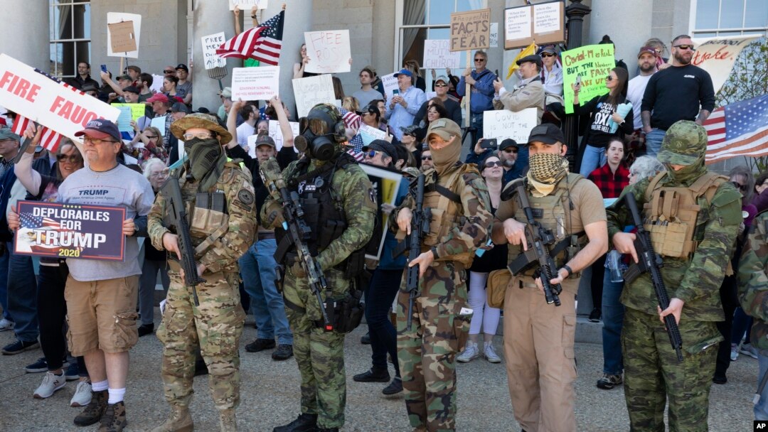 People, including those with the boogaloo movement, demonstrate against business closures due to concern about COVID-19, at the State House in Concord, N.H., May 2, 2020.