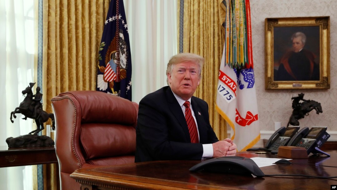 FILE - President Donald Trump answers questions from the media after speaking with members of the military by video conference on Christmas Day, Dec. 25, 2018, in the Oval Office of the White House. 