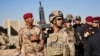 Iraqi soldier stands guard as army generals gather for news conference announcing their victory in Gogjali, a village on the edge of Mosul, Iraq, Nov. 3, 2016. (Photo: Jamie Dettmer for VOA) 