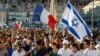 Supporters of Israel’s Gaza offensive wave Israeli and French flags at a demonstration in Marseille, France, July 27, 2014. The radical Jewish Defense League, not shown, uses strong-arm tactics to fight anti-Semitism.