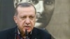 Turkey's President Recep Tayyip Erdogan, backdropped by a portrait of Turkish Republic founder Mustafa Kemal Ataturk, talks to members of the media in Istanbul, prior to his departure on a Mideast tour, Feb. 12, 2017.