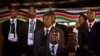 FILE - Security and bodyguards of the election commission chairman stand as he delivers a statement to the media, at the National Election Center, March 8, 2013.