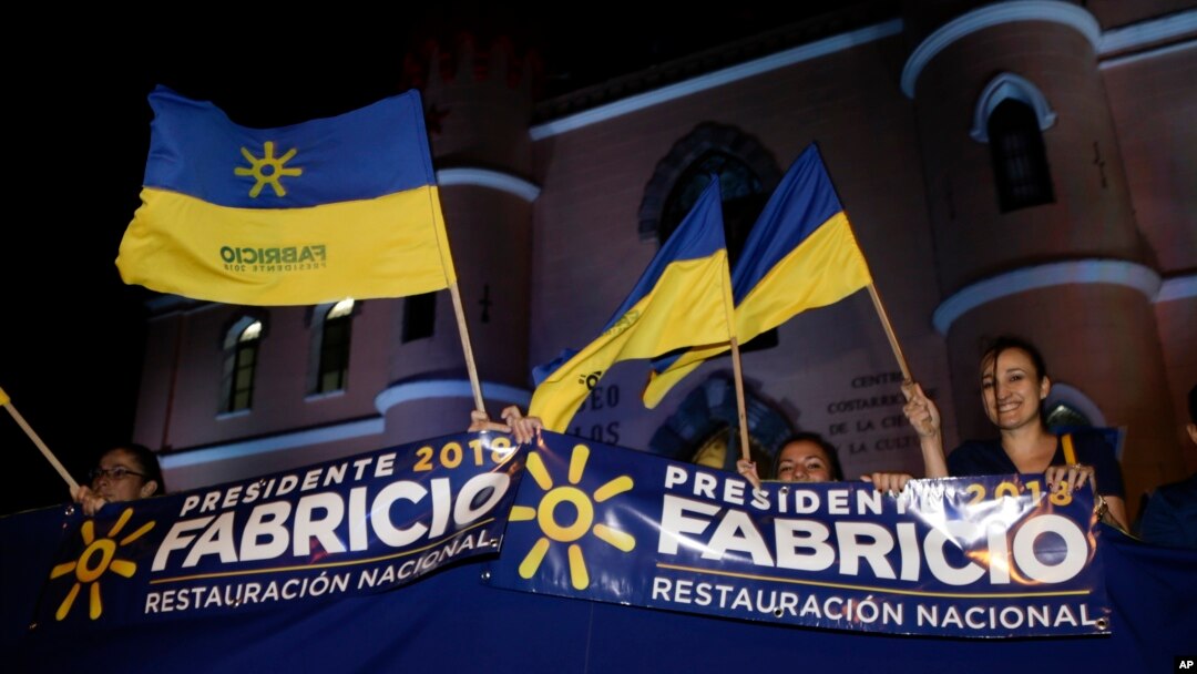 Supporters of presidential candidate Fabricio Alvarado with the National Restoration party gather before a debate ahead of the presidential election in San Jose, Costa Rica, Feb. 1, 2018. Costa Ricans head to the polls Sunday.