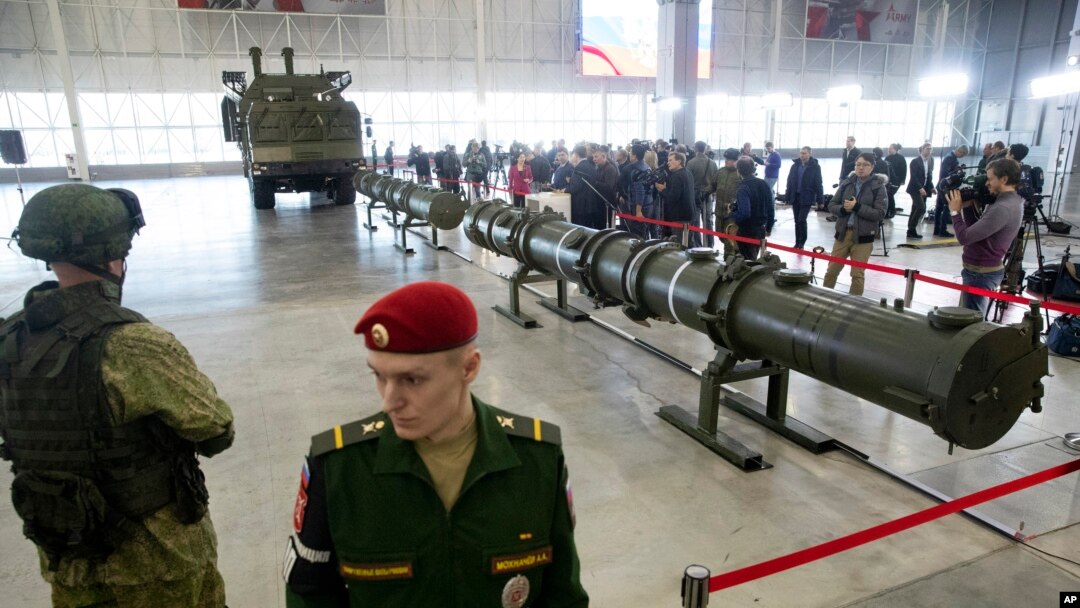 FILE - Russian military officers stand by as the 9M729, center, its launcher, left, and the 9M728, right, land-based cruise missiles are displayed in Kubinka outside Moscow, Russia, Jan. 23, 2019. 