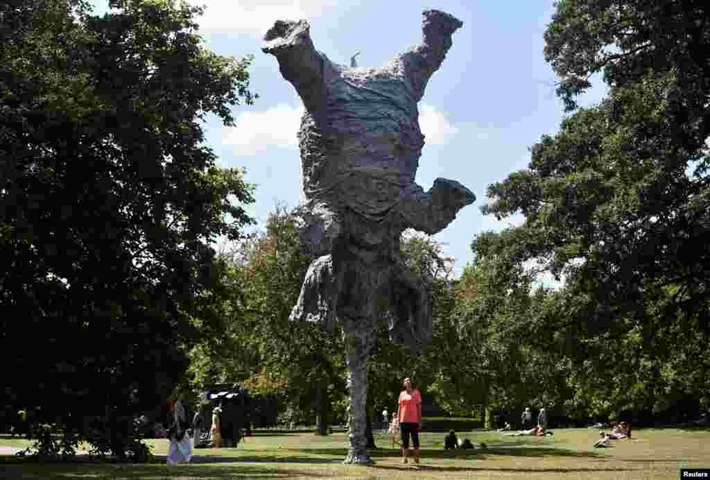 A woman views Miquel Barcelo&#39;s sculpture &quot;Gran Elefandret&quot; at the Frieze Sculpture exhibition in London.