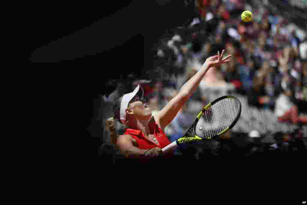 Denmark's Caroline Wozniacki serves against Latvia's Jelena Ostapenko during their quarterfinal match of the French Open tennis tournament at the Roland Garros stadium, in Paris.