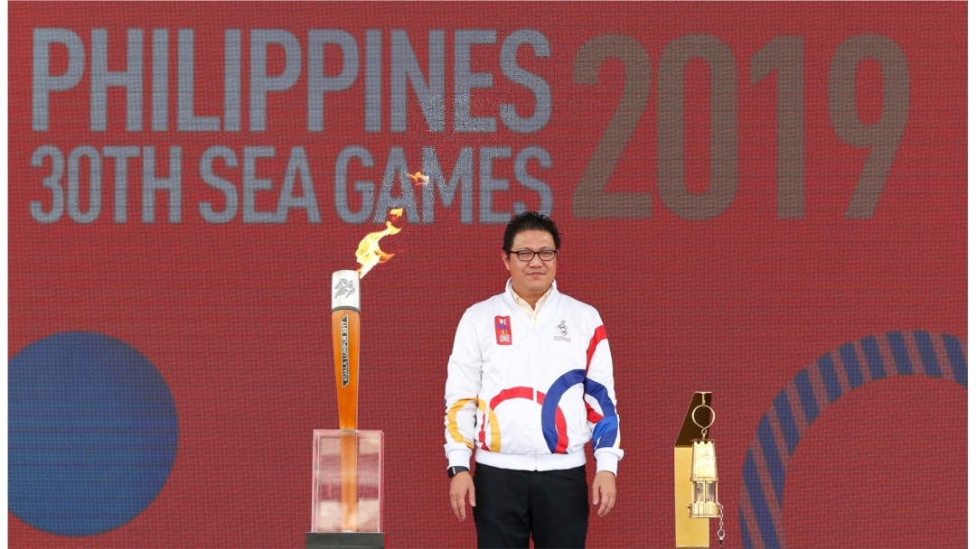 Philippines Southeast Asian Games Organizing Committee Chief Opening Officer Ramon Suzara poses with the Southeast Asian Games torch and lantern during the Flame Handover Ceremony for the 30th Southeast Asian Games in Kuala Lumpur, Malaysia.