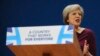 British Prime Minister Theresa May addresses delegates at the Conservative Party Conference at the ICC, in Birmingham, England, Oct. 5, 2016. May's government alarmed liberals by saying that businesses should prioritize hiring Britons.