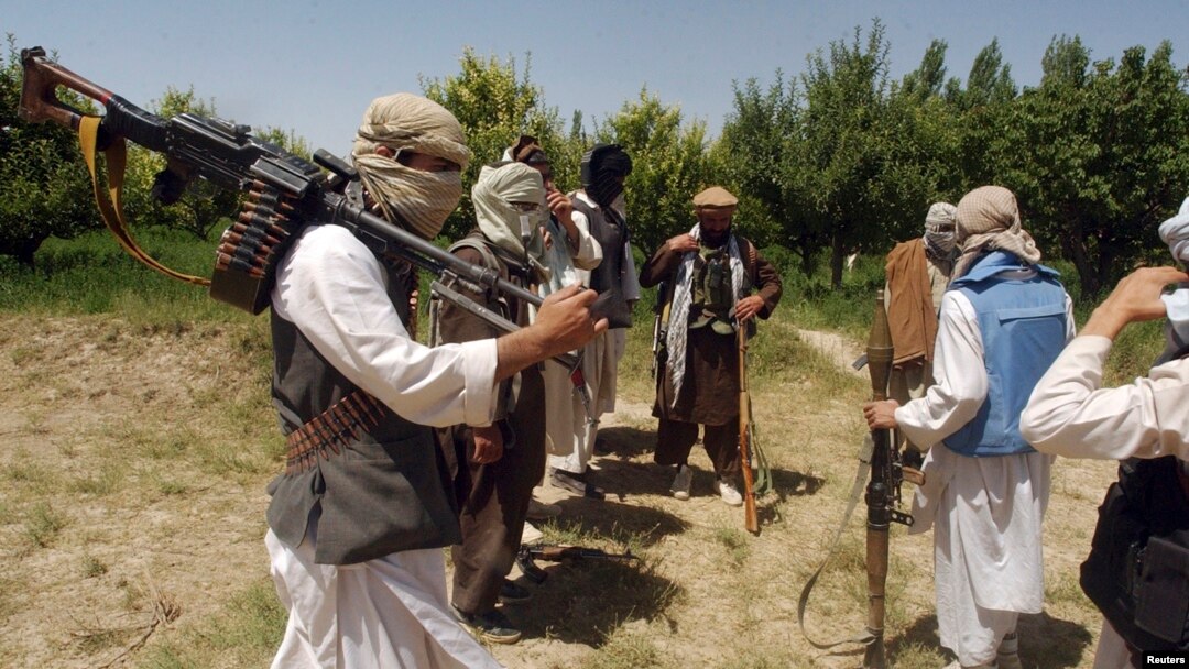 FILE - Taliban fighters are seen in an undisclosed location in Afghanistan, July 14, 2009.