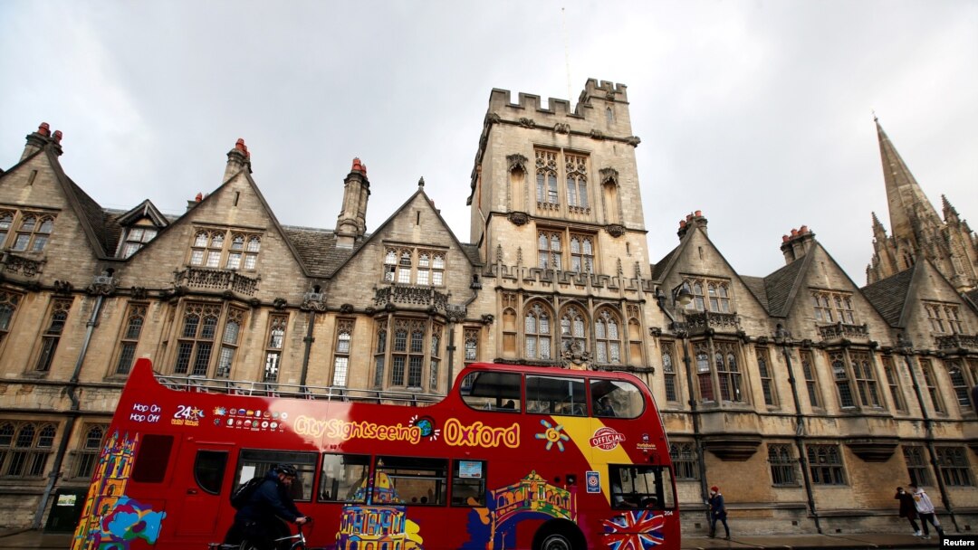FILE - A sightseeing bus passes Oxford University building, amid the spread of the coronavirus disease (COVID-19), in Oxford, Britain, Oct. 6, 2020. 