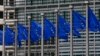 FILE - European Union flags are seen outside the European Commission headquarters in Brussels, Sept. 10, 2014. 