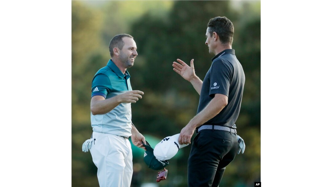 Sergio Garcia, left, shakes hands with Justin Rose, after making his birdie putt on the 18th green to win the Masters.