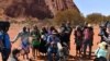 FILE - Australian Aboriginals speak to members of the media at Uluru-Kata Tjuta National Park in Australia's Northern Territory, Oct. 26, 2019.