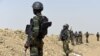 FILE - A picture taken on February 17, 2015 shows Cameroonian soldiers patrolling in the Cameroonian town of Fotokol, on the border with Nigeria. A spokesman for the government of Cameroon said more than 160 Boko Haram fighters were killed and hundreds of hostages, both Cameroonian and Nigerian, freed in the liberation of Goshi.