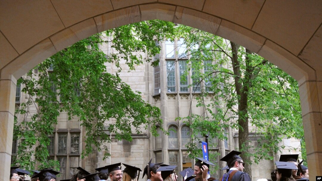 FILE - Future graduates wait for the procession to begin for commencement at Yale University in New Haven, Conn., May 24, 2010.