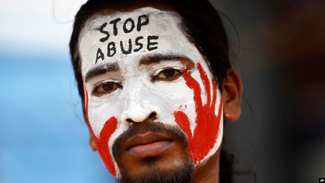 An Indian protester with a slogan painted on his face participates in a demonstration to protest against police inaction after a 6-year-old was allegedly raped in a school in Bangalore, India, July 20, 2014. 