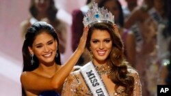 Iris Mittenaere of France is crowned the new Miss Universe 2016 by 2015 Miss Universe Pia Wurtzbach, Jan. 30, 2017.