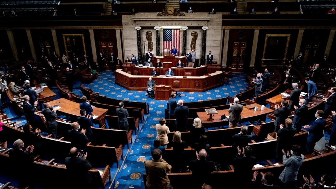 FILE - Republican and Democrats clap while House Minority Leader Kevin McCarthy (R-CA) commends Capitol Police and law enforcement for their work after rioters supporting President Donald Trump breached the Capitol.
